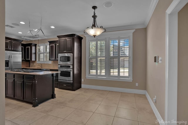 kitchen featuring decorative backsplash, appliances with stainless steel finishes, dark brown cabinetry, and crown molding