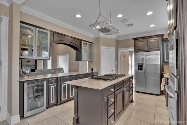 kitchen with wine cooler, crown molding, a center island, and stainless steel appliances