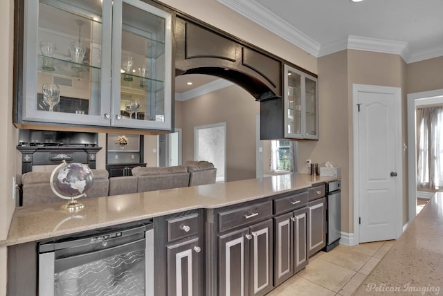 kitchen featuring light tile patterned floors, crown molding, light stone countertops, dark brown cabinetry, and beverage cooler