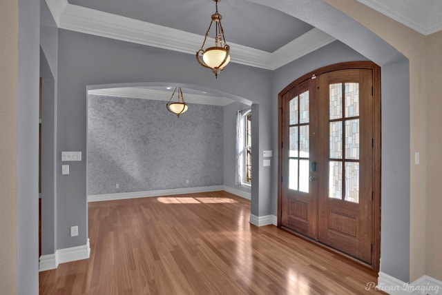 entryway featuring french doors, ornamental molding, and light hardwood / wood-style flooring