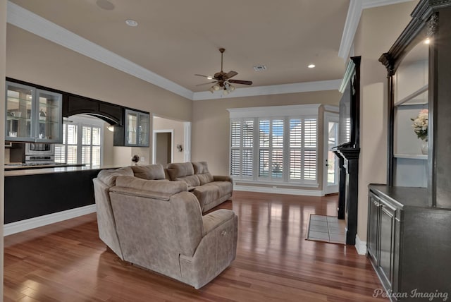 living room with crown molding, hardwood / wood-style flooring, and ceiling fan