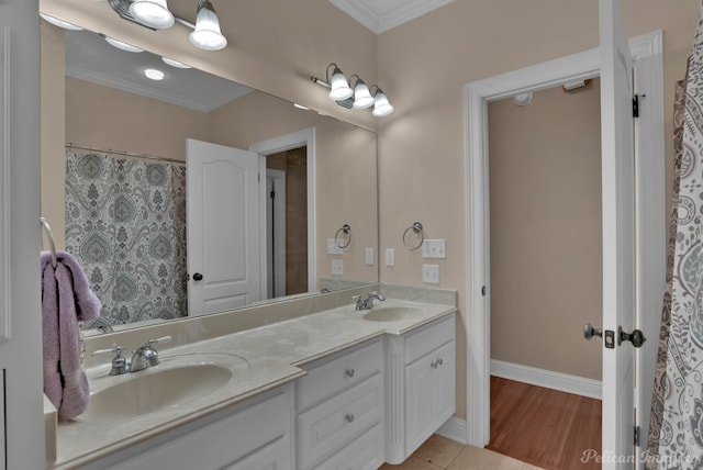 bathroom featuring vanity, crown molding, and hardwood / wood-style flooring