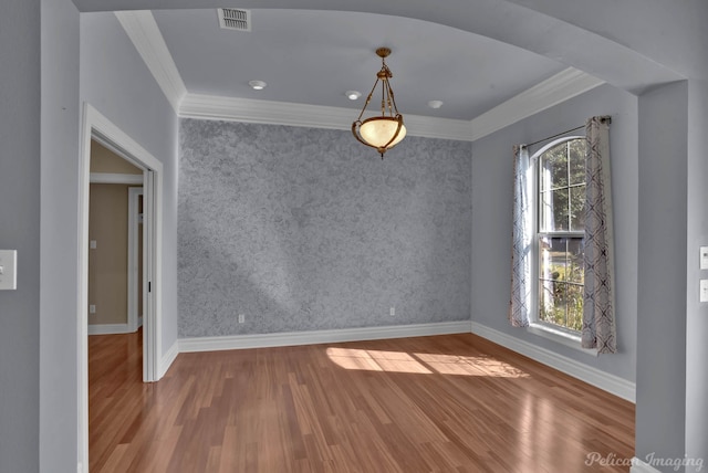 unfurnished dining area featuring hardwood / wood-style flooring, ornamental molding, and a wealth of natural light