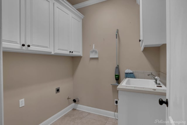 washroom with cabinets, light tile patterned floors, crown molding, hookup for an electric dryer, and sink