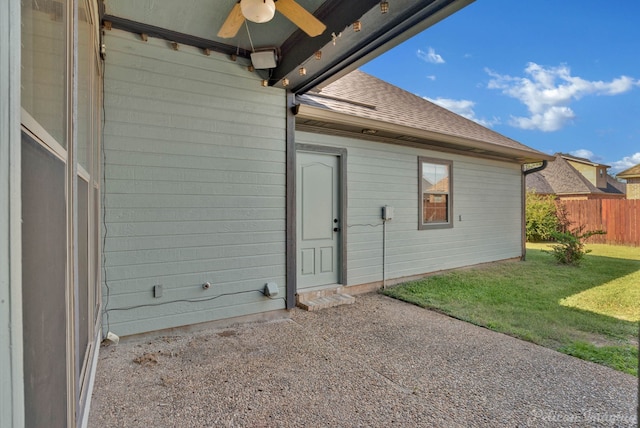 doorway to property featuring a patio and a lawn