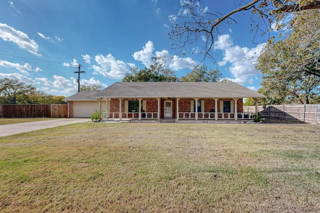 single story home with a front lawn, covered porch, and a garage