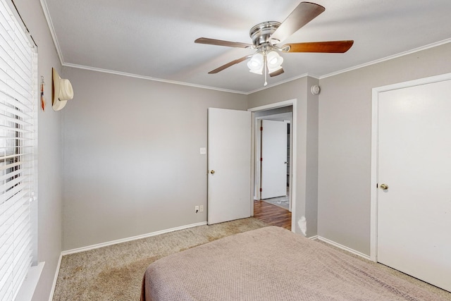 bedroom featuring ceiling fan, crown molding, and light colored carpet