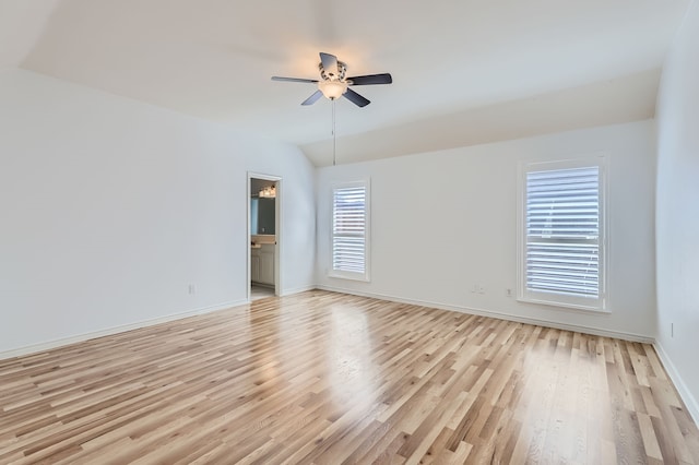 spare room with ceiling fan, lofted ceiling, and light wood-type flooring