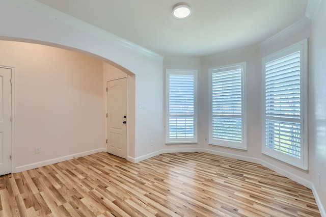 unfurnished room featuring light hardwood / wood-style floors and ornamental molding