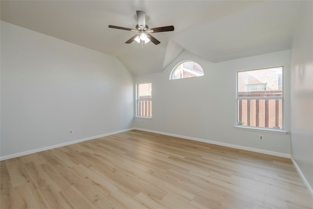 unfurnished room featuring ceiling fan, vaulted ceiling, and light wood-type flooring