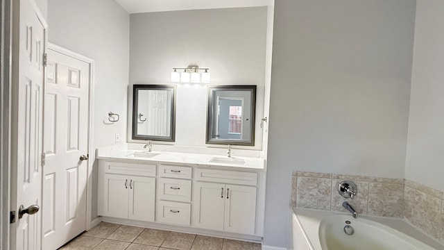 bathroom with vanity, tile patterned floors, and a bath