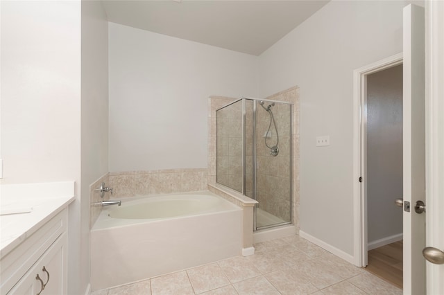 bathroom featuring vanity, independent shower and bath, and tile patterned floors