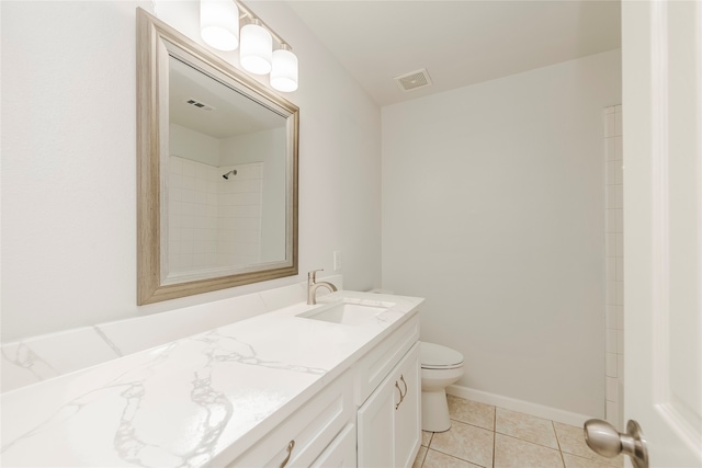 bathroom featuring vanity, toilet, tile patterned floors, and walk in shower