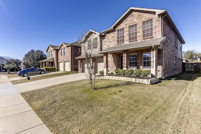 traditional-style house featuring brick siding, a front lawn, fence, concrete driveway, and a garage