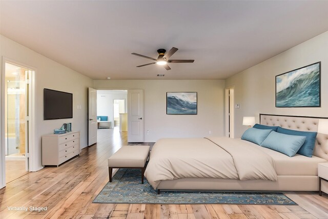 bedroom featuring a ceiling fan, light wood-type flooring, and ensuite bathroom