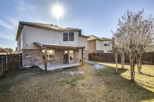 back of house with a yard and a patio area