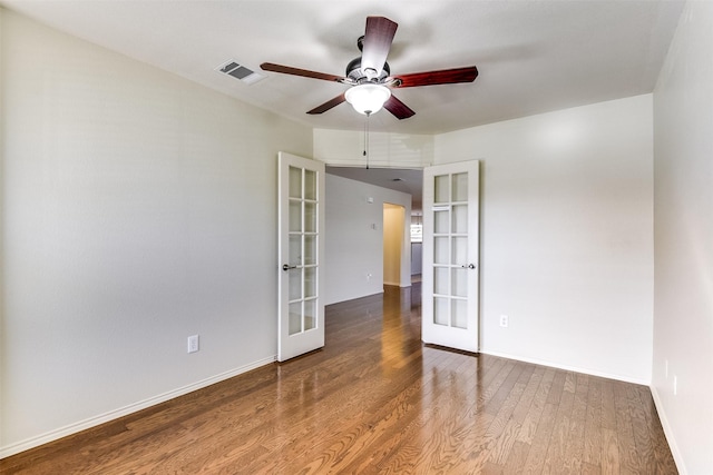 unfurnished room featuring visible vents, baseboards, french doors, wood finished floors, and a ceiling fan