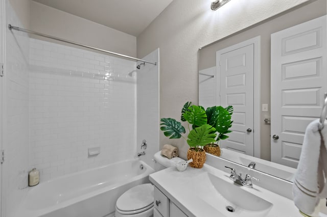 full bathroom with toilet, tiled shower / bath, and vanity