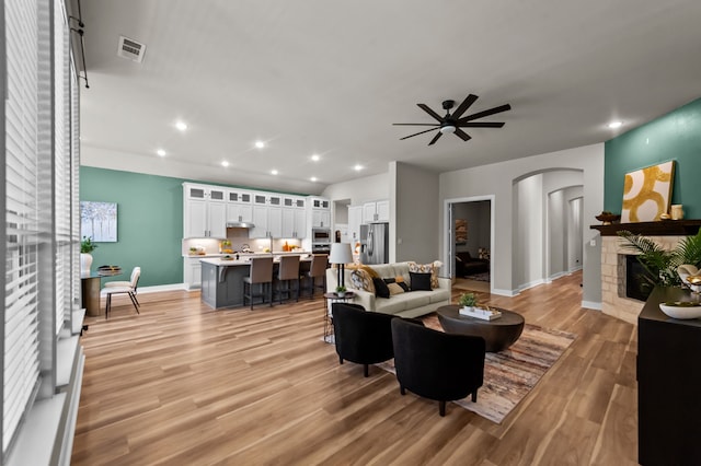 living room featuring light wood-type flooring and ceiling fan