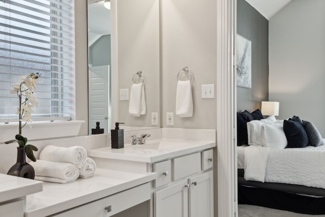 bathroom featuring ensuite bath and vanity