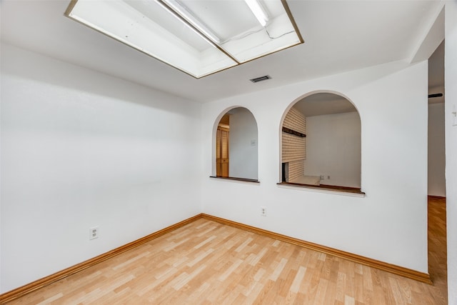 unfurnished room with wood-type flooring