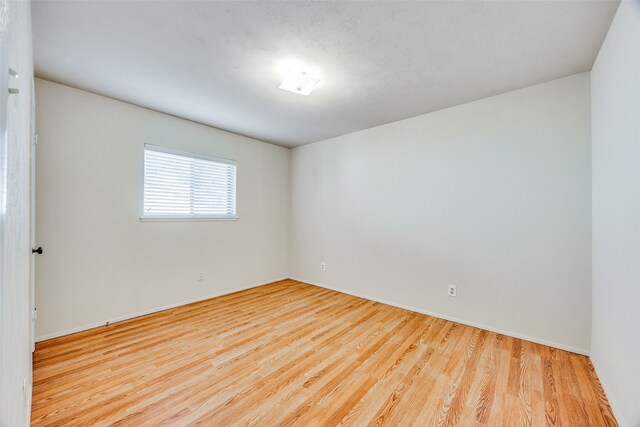 empty room with light hardwood / wood-style floors