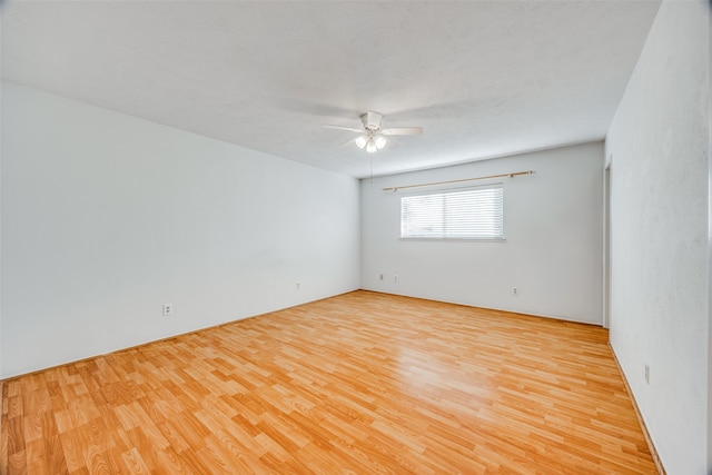 spare room featuring light hardwood / wood-style floors and ceiling fan