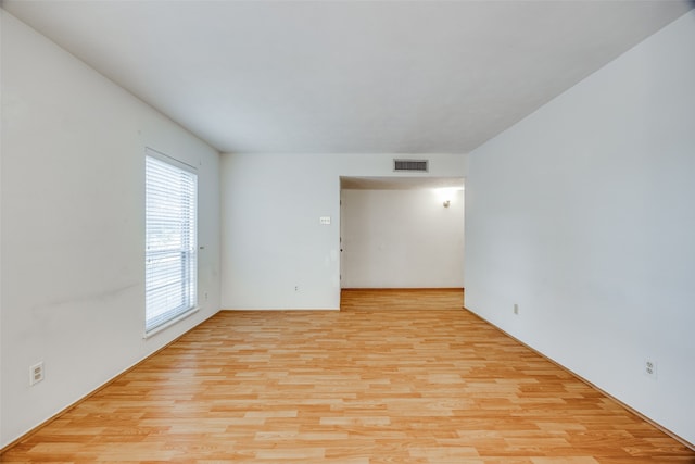 spare room featuring light wood-type flooring