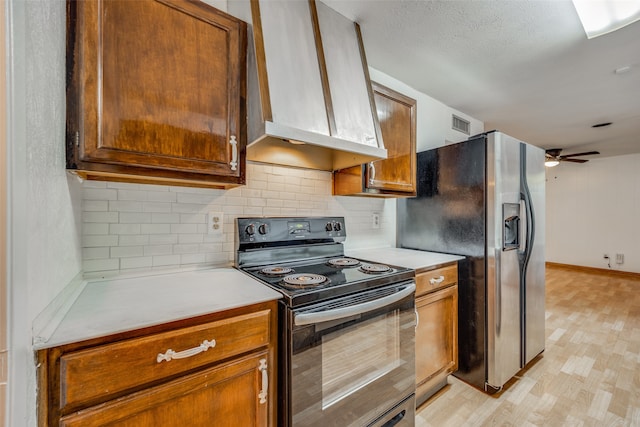 kitchen with exhaust hood, stainless steel fridge, electric range, light wood-type flooring, and ceiling fan