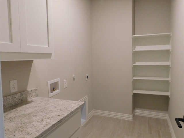 laundry area featuring cabinets, washer hookup, gas dryer hookup, light hardwood / wood-style floors, and hookup for an electric dryer