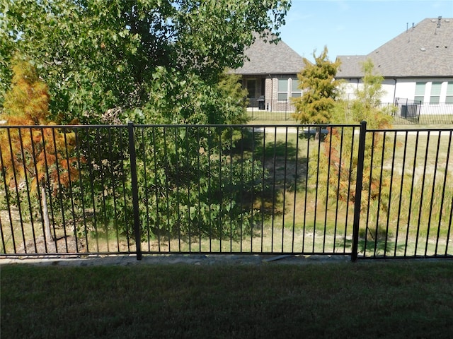 view of gate featuring a lawn