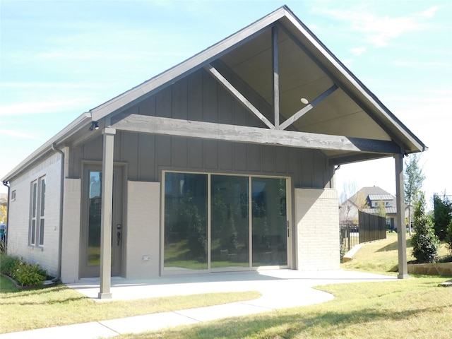 back of house with a lawn