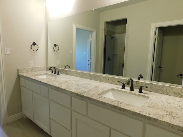 bathroom with vanity and a shower with shower door