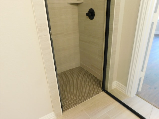 bathroom with tile patterned floors and a shower with shower door