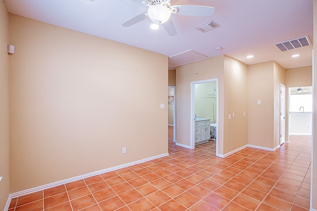 spare room featuring ceiling fan and light tile patterned floors