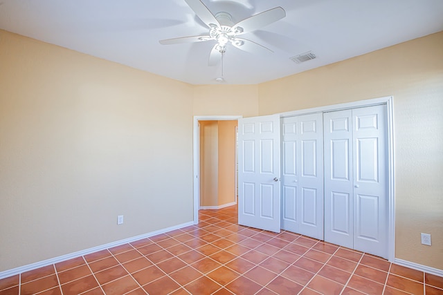 unfurnished bedroom with a closet, ceiling fan, and light tile patterned floors