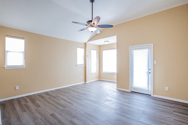 spare room featuring vaulted ceiling, hardwood / wood-style flooring, and ceiling fan