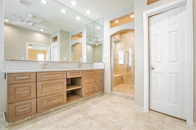 bathroom featuring vanity, tiled shower, and ceiling fan