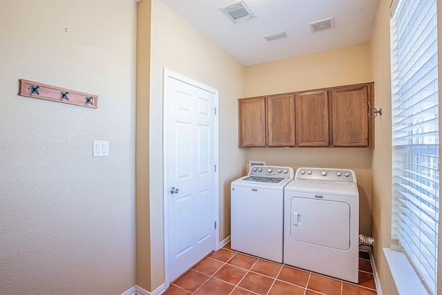 washroom featuring cabinets, independent washer and dryer, and light tile patterned floors