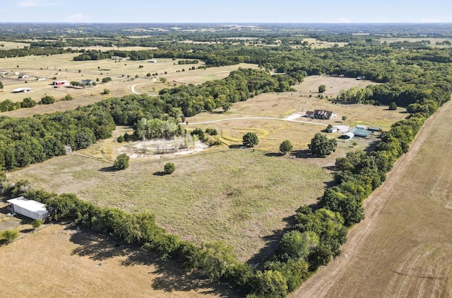 birds eye view of property with a rural view