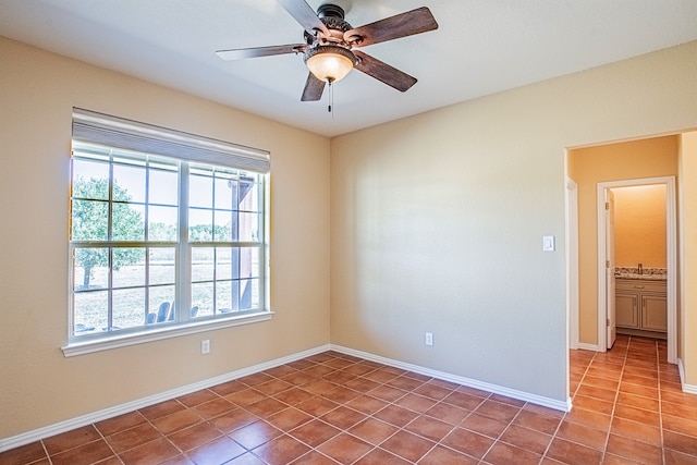 unfurnished room with tile patterned flooring and ceiling fan