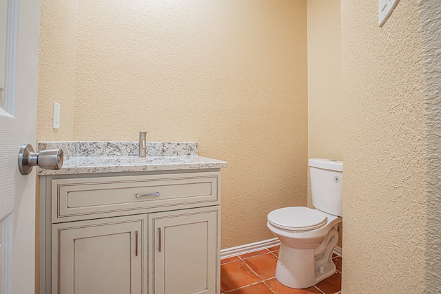 bathroom with vanity, toilet, and tile patterned flooring