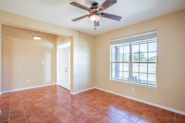 tiled empty room with ceiling fan