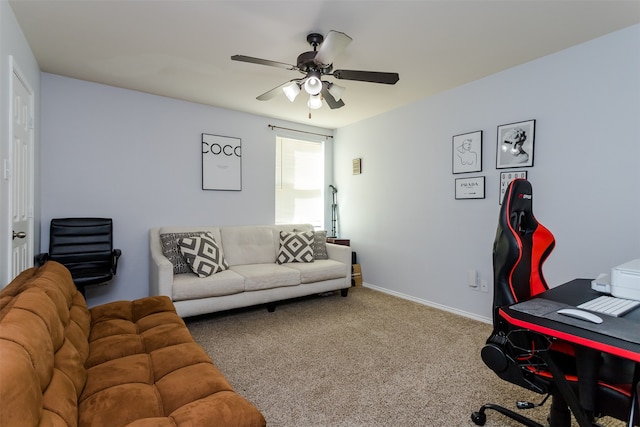 carpeted home office featuring ceiling fan