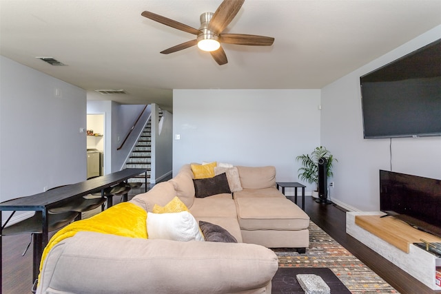 living room with ceiling fan and dark hardwood / wood-style flooring