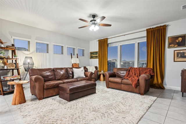 tiled living room with ceiling fan