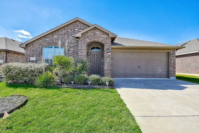 view of front of house featuring a front yard and a garage