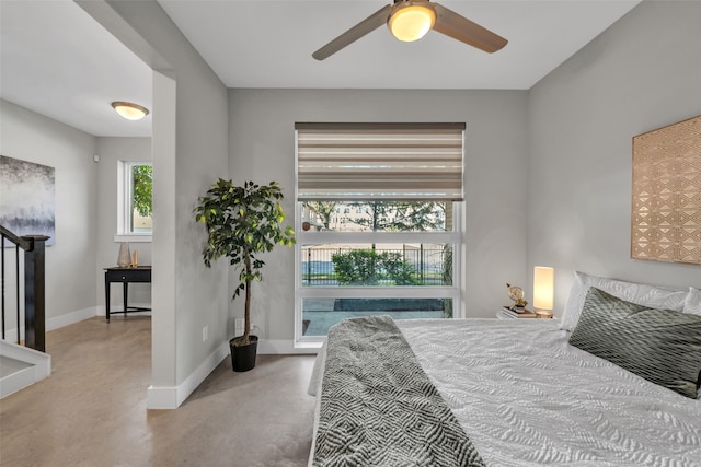 bedroom with ceiling fan and multiple windows