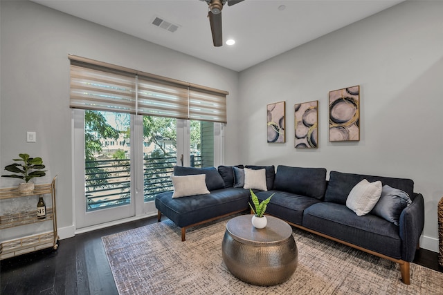 living room featuring hardwood / wood-style floors and ceiling fan