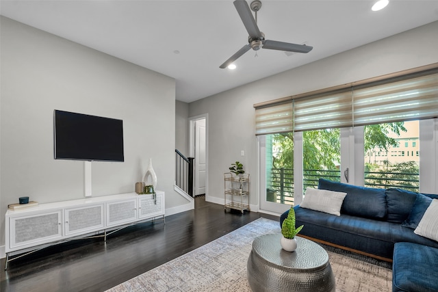 living room featuring dark hardwood / wood-style floors and ceiling fan